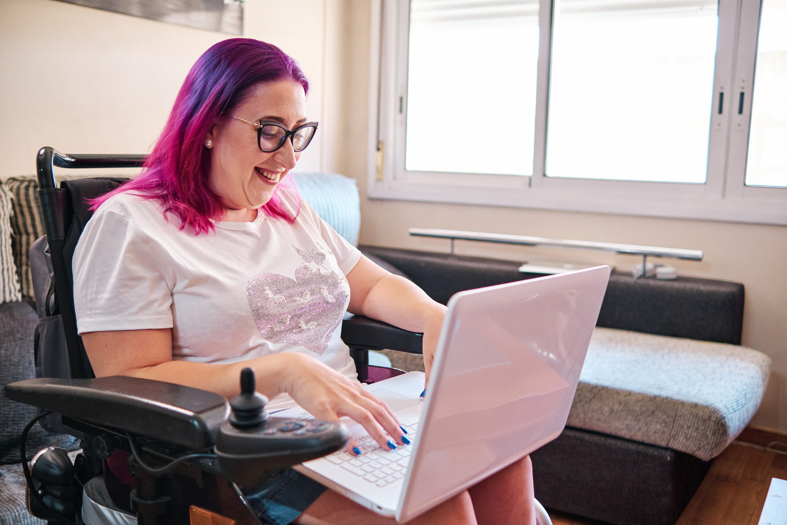 woman in a wheelchair with a laptop
