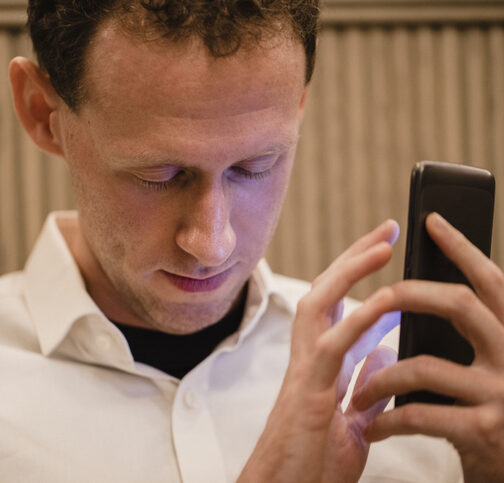 Blind man using mobile phone