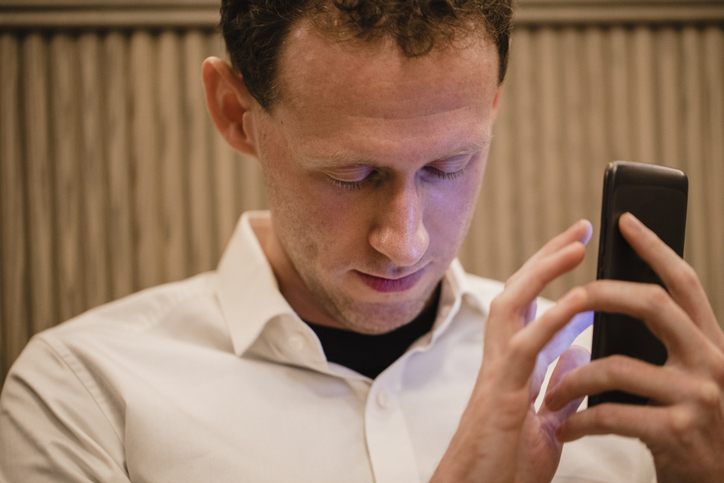 Blind man using mobile phone